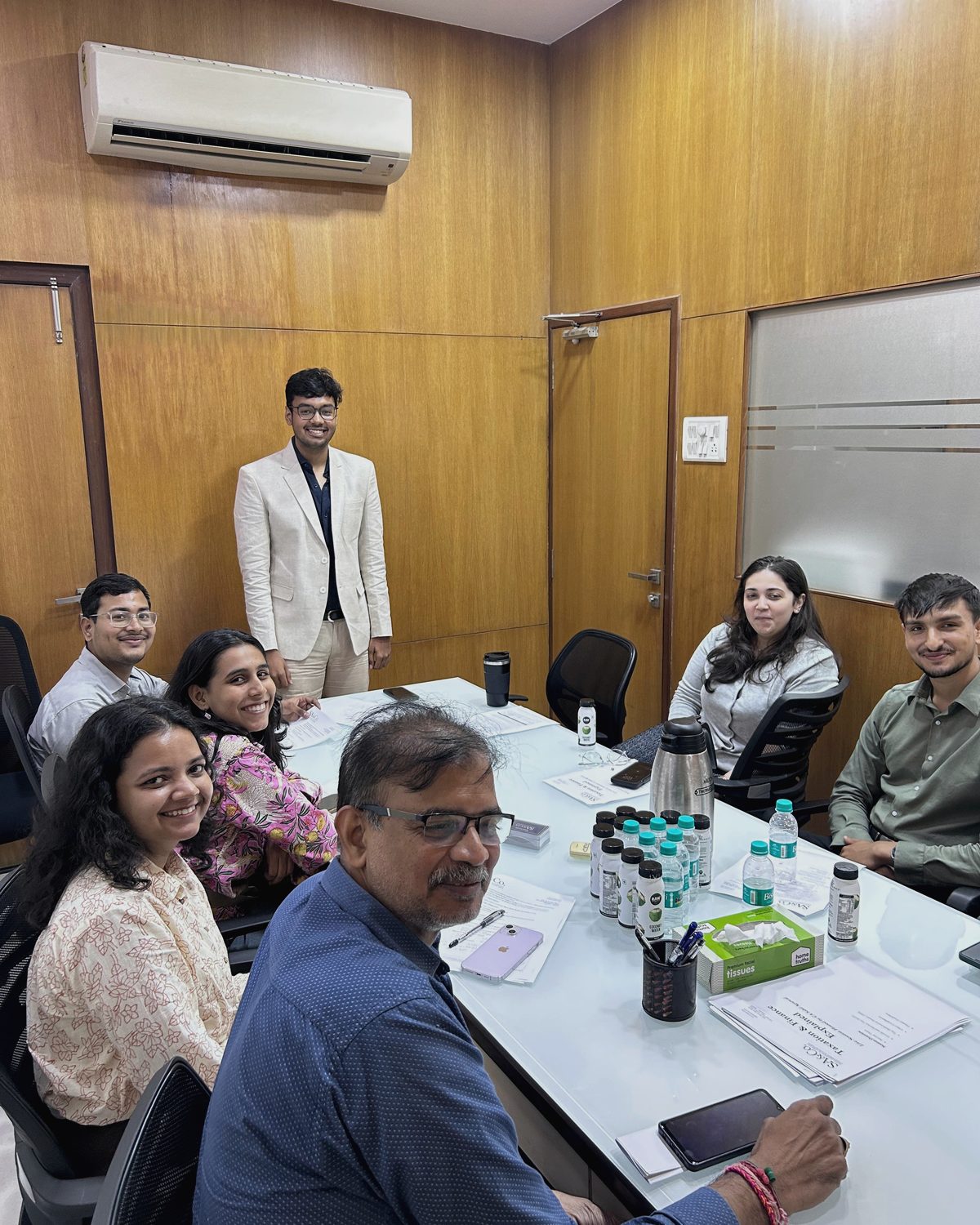 Sahil leading a workshop session around the table